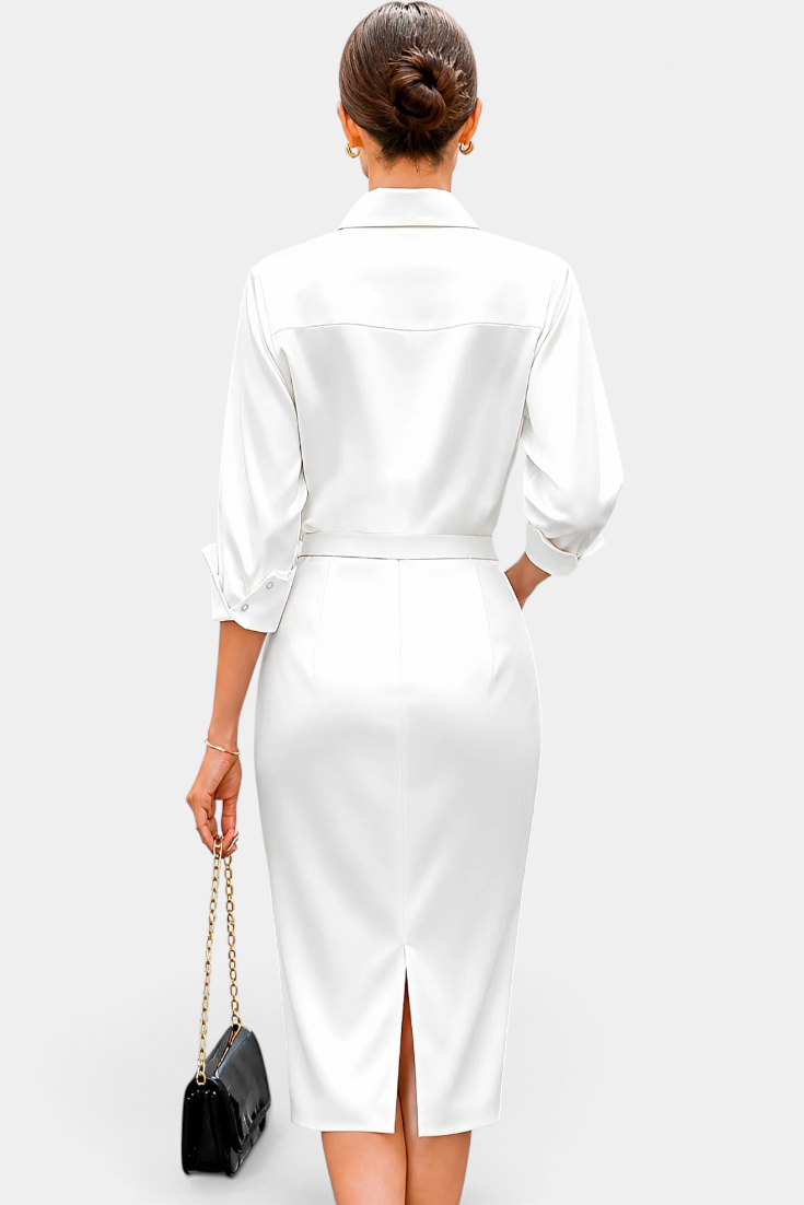 Back view of Mahaute Macarena white satin midi shirt dress with long sleeves, belted waist, and back slit