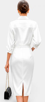 Back view of Mahaute Macarena white satin midi shirt dress with long sleeves, belted waist, and back slit