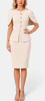 Robe mi-longue beige Mahaute Machteld avec cape ajustée, manches longues et détails de boutons dorés visible sur l'image.