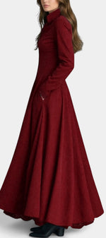 Mahaute Maravilla long burgundy faux suede shirt dress with a cinched waist and flared skirt worn by a model
