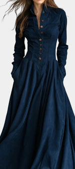 Mahaute Maravilla long navy blue faux suede shirt dress with a structured collar, button-down front, and flared skirt.