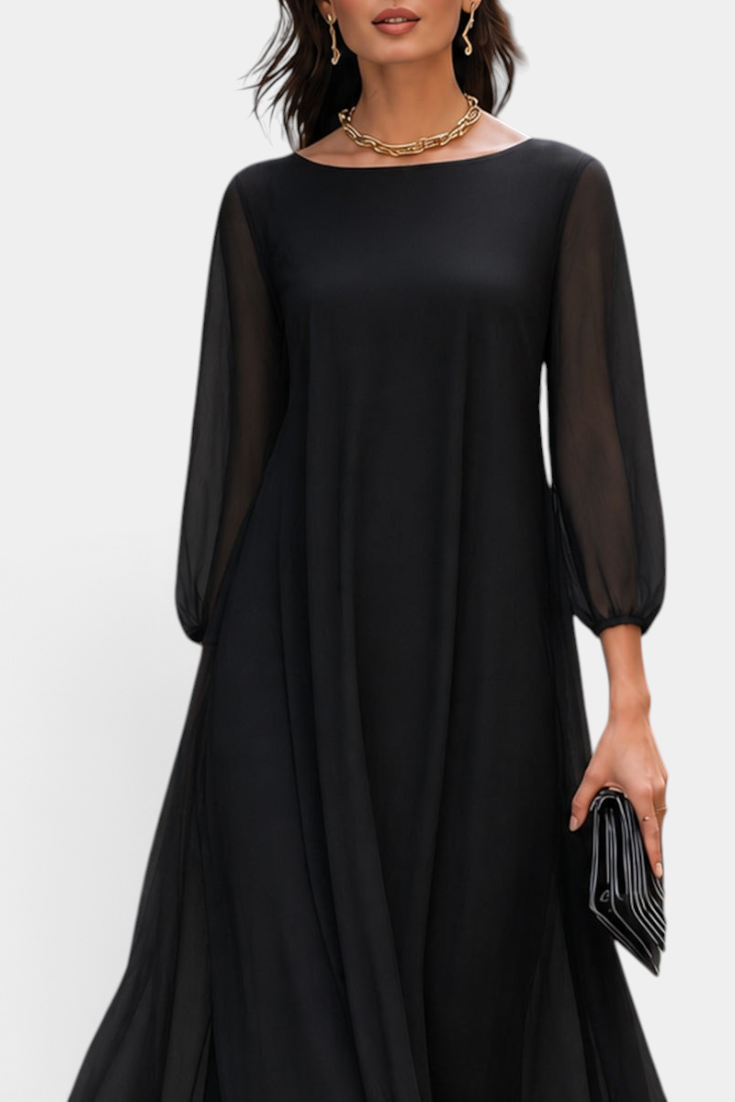 Mahaute Mazarine black long flowing dress with sheer sleeves and a rounded neckline worn by a model