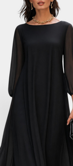 Mahaute Mazarine black long flowing dress with sheer sleeves and a rounded neckline worn by a model