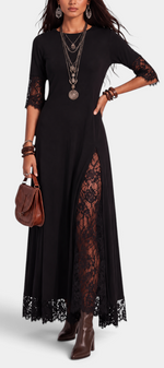 Mahaute Meliorine black maxi dress with floral lace sleeves, side panels, and hem detail on a model.