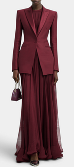 Mahaute Merryn two-piece set featuring a structured burgundy blazer and a matching floor-length pleated dress.