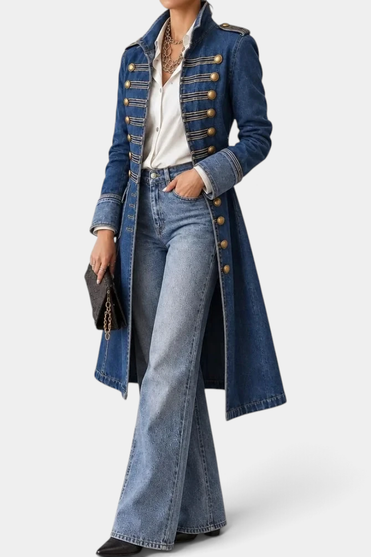 Mahaute mid-length blue denim jacket with military-style gold buttons and structured collar, worn over a white shirt.