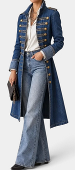 Mahaute mid-length blue denim jacket with military-style gold buttons and structured collar, worn over a white shirt.