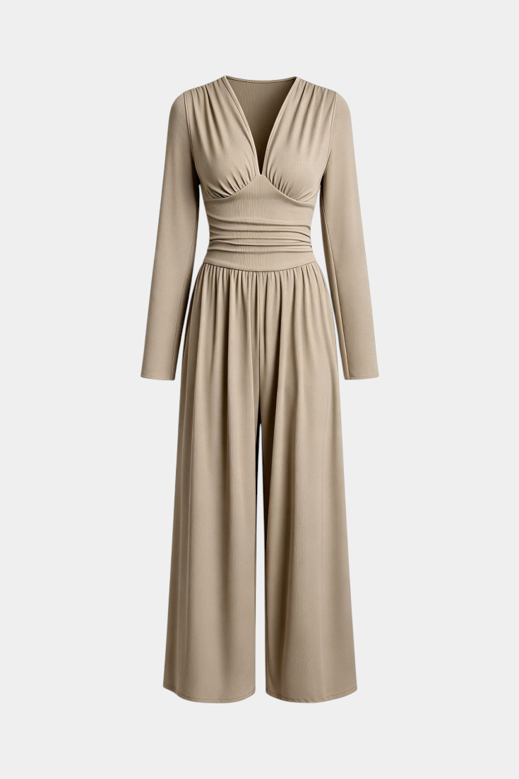 Mahaute Mirabel beige long-sleeve jumpsuit with a V-neck, gathered bodice, cinched waist, and wide-leg trousers.