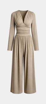 Mahaute Mirabel beige long-sleeve jumpsuit with a V-neck, gathered bodice, cinched waist, and wide-leg trousers.