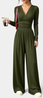 Mahaute Mirabel olive green long-sleeve jumpsuit with a V-neck, ruched bodice, cinched waist, and wide-leg trousers.