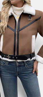 Mahaute Monet brown faux suede aviator jacket with white faux fur collar, black trim, zip closure, and waist belt.