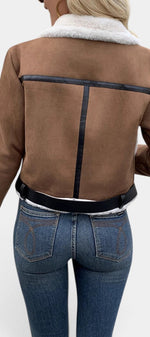 Back view of Mahaute Monet short faux suede jacket in brown with white faux fur collar and black trim details.
