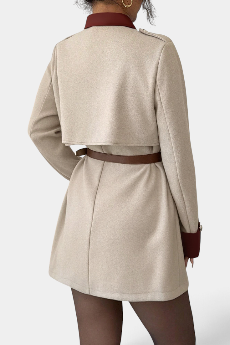 Mahaute Montrielle beige short coat with brown contrast collar, belt, and cape-style back yoke.
