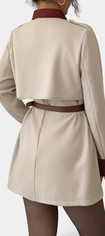 Mahaute Montrielle beige short coat with brown contrast collar, belt, and cape-style back yoke.