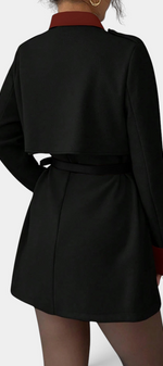 Mahaute Montrielle short black coat with burgundy contrast collar, belted waist, and cape-style back yoke.