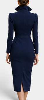 Back view of a Mahaute navy blue midi dress with a structured high collar, cinched waist, and back slit.