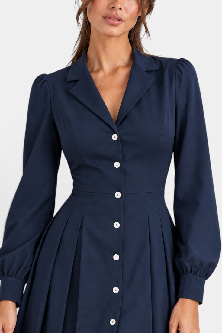 Mahaute navy blue shirt dress with a collared neckline, button-down front, cinched waist, and pleated skirt.