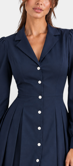 Mahaute navy blue shirt dress with a collared neckline, button-down front, cinched waist, and pleated skirt.