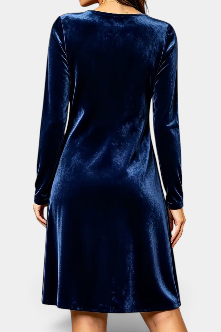 Back view of a Mahaute navy blue velvet short dress with long sleeves and a flared silhouette.