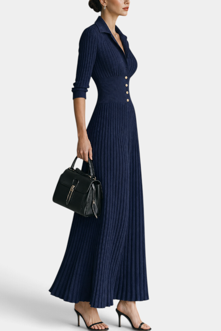 Mahaute Jessamine navy blue ribbed knit maxi dress with shirt collar, cinched waist, and gold buttons on a model.