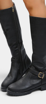 Mahaute Nevena black faux leather knee-high boots with a buckled ankle strap, side zipper, and chunky lug sole.