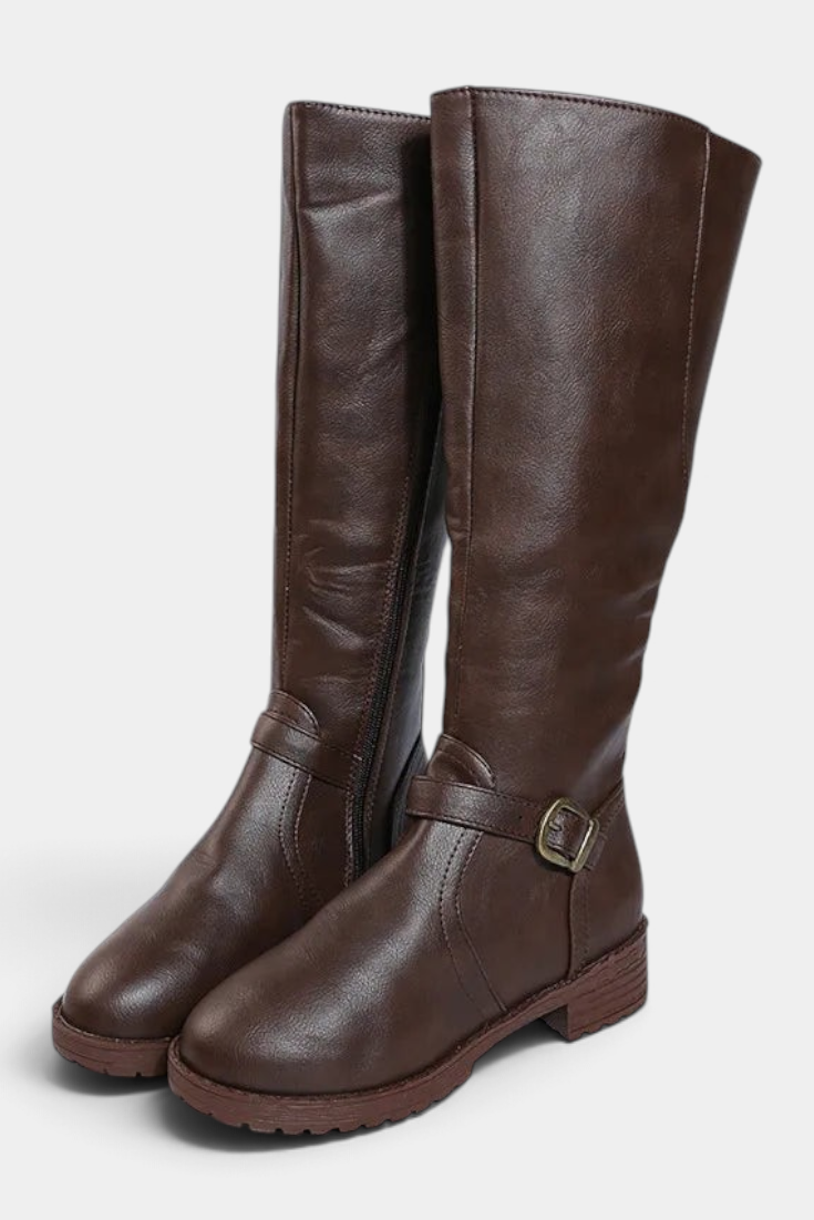 Mahaute Nevena brown faux leather knee-high boots with a buckled ankle strap and a sturdy lug sole.