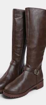 Mahaute Nevena brown faux leather knee-high boots with a buckled ankle strap and a sturdy lug sole.