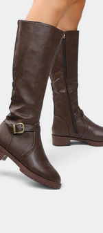 Mahaute Nevena brown faux leather knee-high boots with a decorative ankle buckle strap and a chunky lug sole.