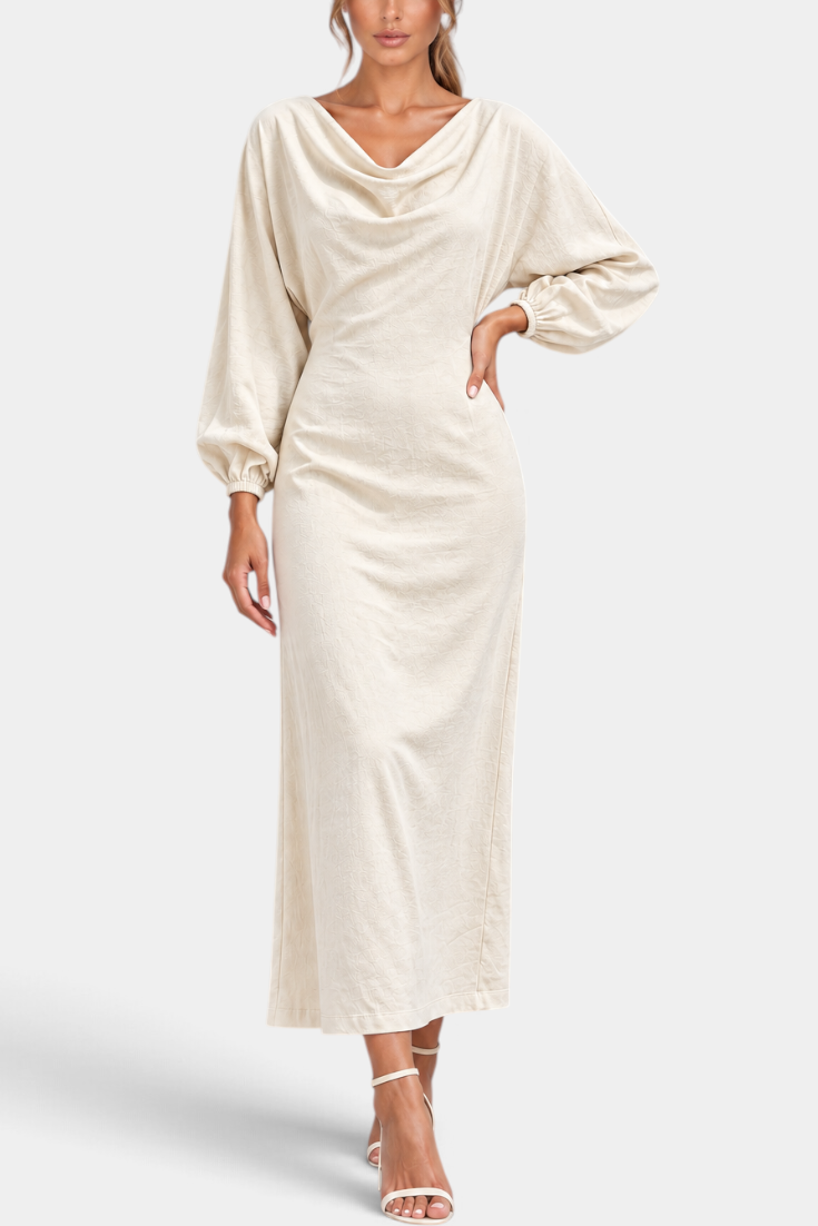Mahaute Nicole long cream dress with draped cowl neck, balloon sleeves, and fitted waist on a model.