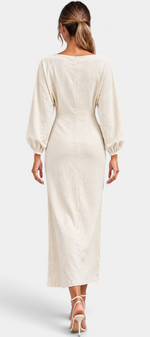 Back view of Mahaute Nicole long cream dress with balloon sleeves and fitted waist on a model with heels