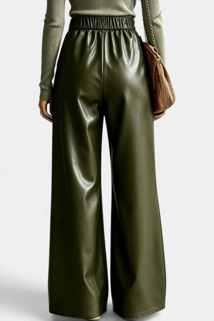 Mahaute Camellia wide-leg trousers in olive green faux leather with an elasticated waist, back view.