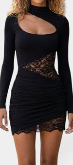 Mahaute Oona black mini dress with asymmetric neckline, lace waist cutouts, and ruched skirt detailing.