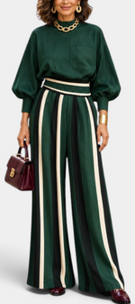 Mahaute Orlianne green blouse with puff sleeves and high-waisted wide-leg trousers featuring vertical stripes.