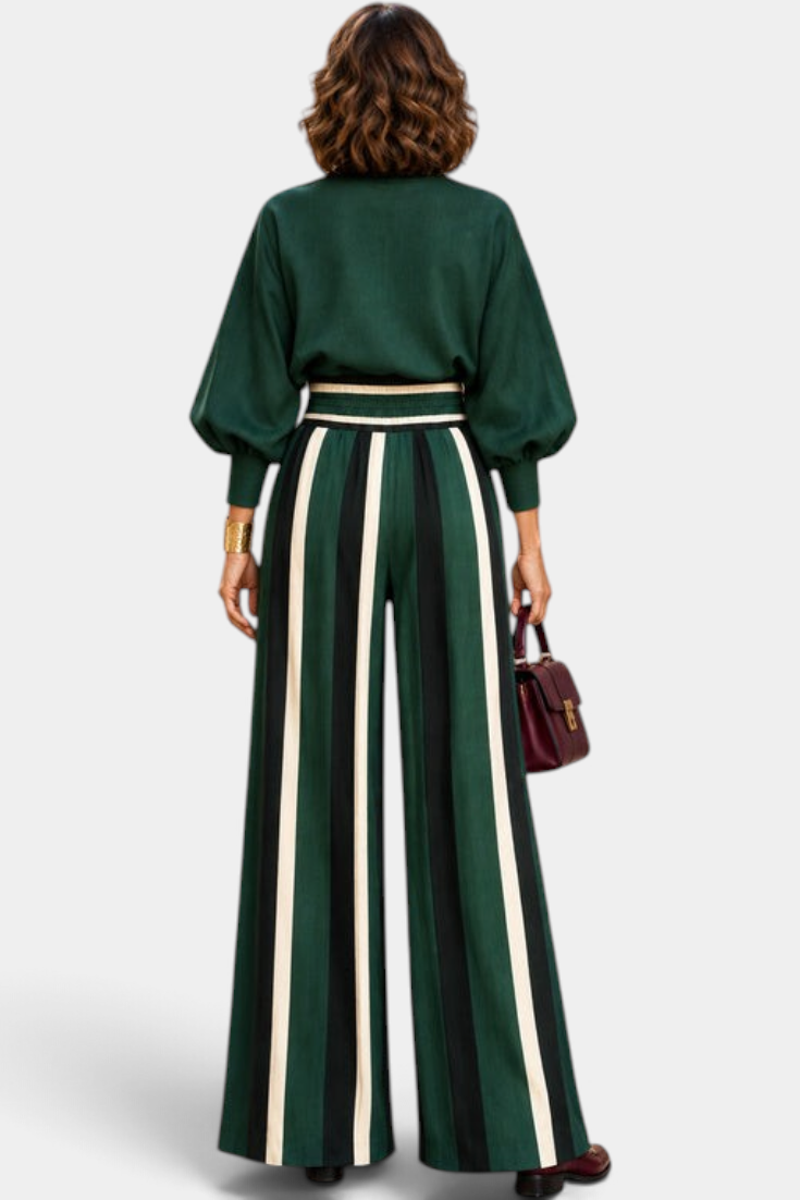 Mahaute Orlianne green blouse with puff sleeves and high-waisted wide-leg trousers featuring vertical stripes.
