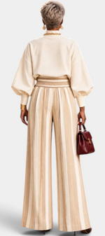 Back view of Mahaute Orlianne cream blouse with puff sleeves and beige striped wide-leg high-waisted trousers.