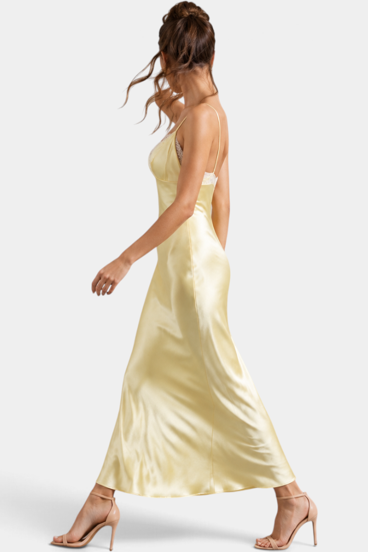 Mahaute long pale yellow satin slip dress with lace V-neck and thin straps worn by a model in profile
