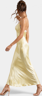Mahaute long pale yellow satin slip dress with lace V-neck and thin straps worn by a model in profile