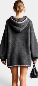 Mahaute Perdita grey oversized knit sweater dress with a hood, balloon sleeves, and pink contrast stitch detailing.