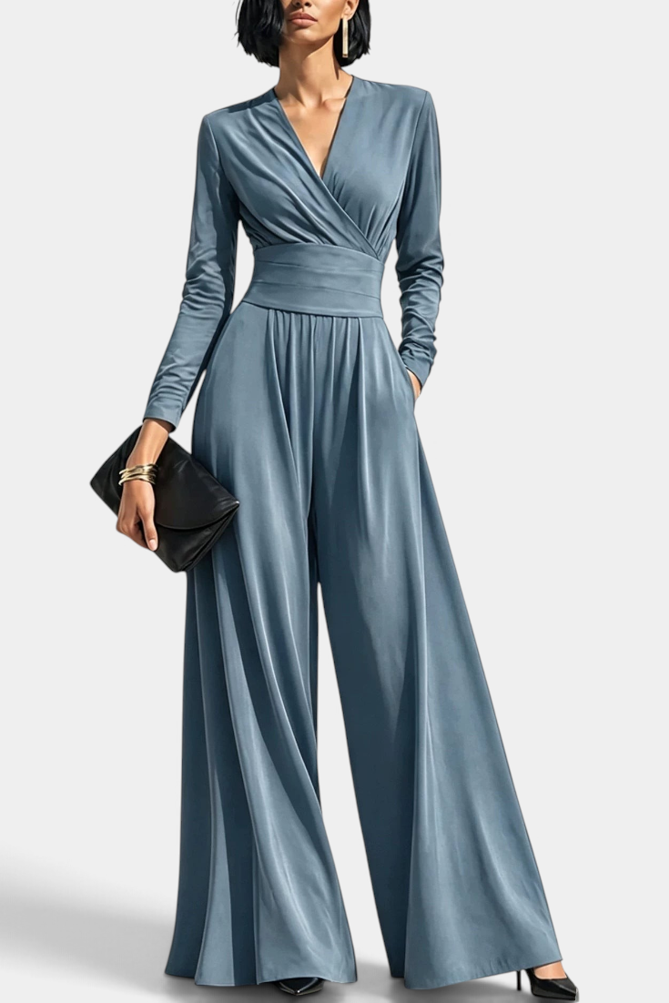 Mahaute Petronella blue long-sleeve wrap jumpsuit with a high waist and wide-leg trousers on a model.