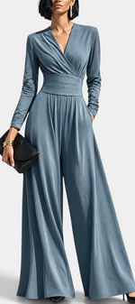 Mahaute Petronella blue long-sleeve wrap jumpsuit with a high waist and wide-leg trousers on a model.