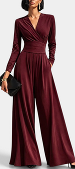 Mahaute Petronella burgundy long-sleeve jumpsuit with a wrap neckline, high waist, and wide-leg trousers.