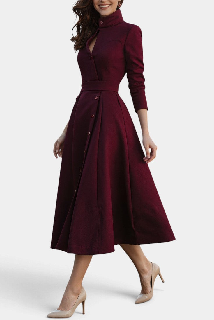Mahaute Prague burgundy midi dress with high collar, button-front, and belted waist on a model wearing beige heels.