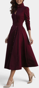 Mahaute Prague burgundy midi dress with high collar, button-front, and belted waist on a model wearing beige heels.