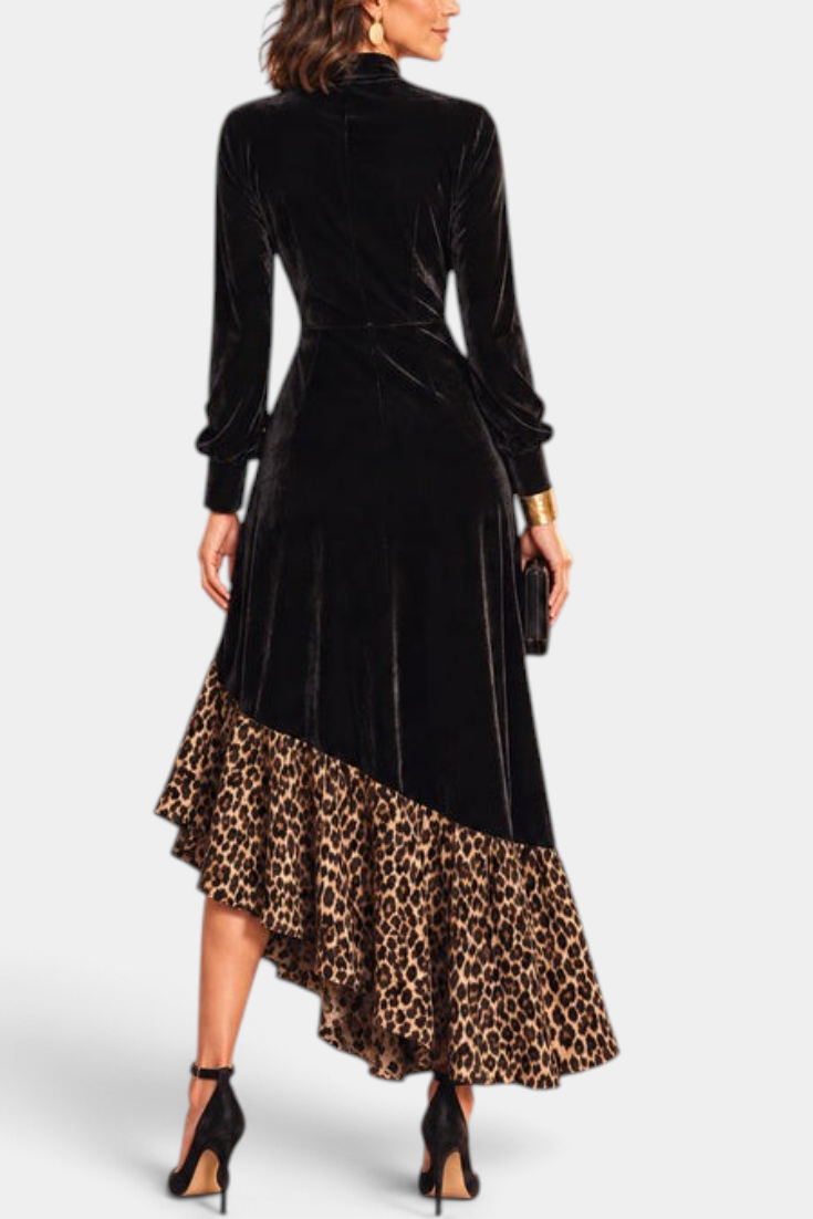 Back view of Mahaute Radostina long black velvet dress with leopard print ruffled asymmetrical hem and high neck.