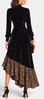 Back view of Mahaute Radostina long black velvet dress with leopard print ruffled asymmetrical hem and high neck.