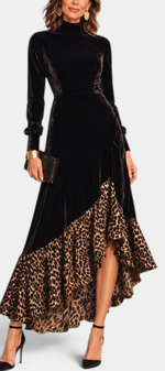 Mahaute Radostina long black velvet dress with a high neck, long sleeves, and an asymmetrical leopard print ruffle hem.