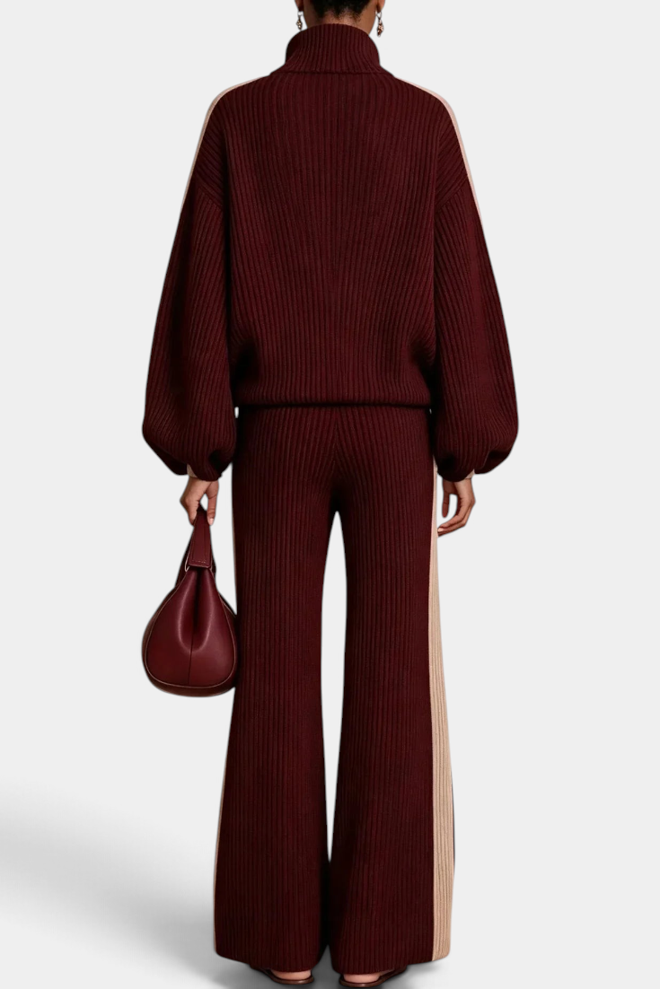 Back view of Mahaute Radostina ribbed knit set in burgundy with beige side stripes, zip jacket and wide-leg pants.