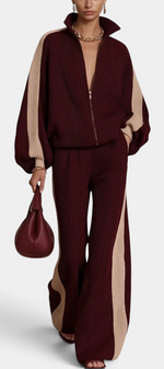 Mahaute Radostina burgundy and beige ribbed knit zip-up jacket and wide-leg trousers set with contrast side stripes.