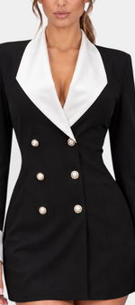 Mahaute Rebecca short black blazer dress with white contrast lapels, cuffs, and decorative pearl buttons.