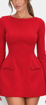 Mahaute red structured short dress with long sleeves, cinched waist, and decorative bow details on the hips.